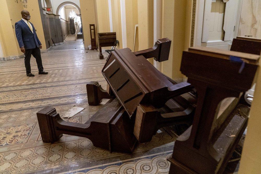 Sen. Tim Scott, R-S.C., stops to look at damage in the early morning hours of Thursday, Jan. 7, 2021, after protesters stormed the Capitol in Washington, on Wednesday. (AP Photo/Andrew Harnik)