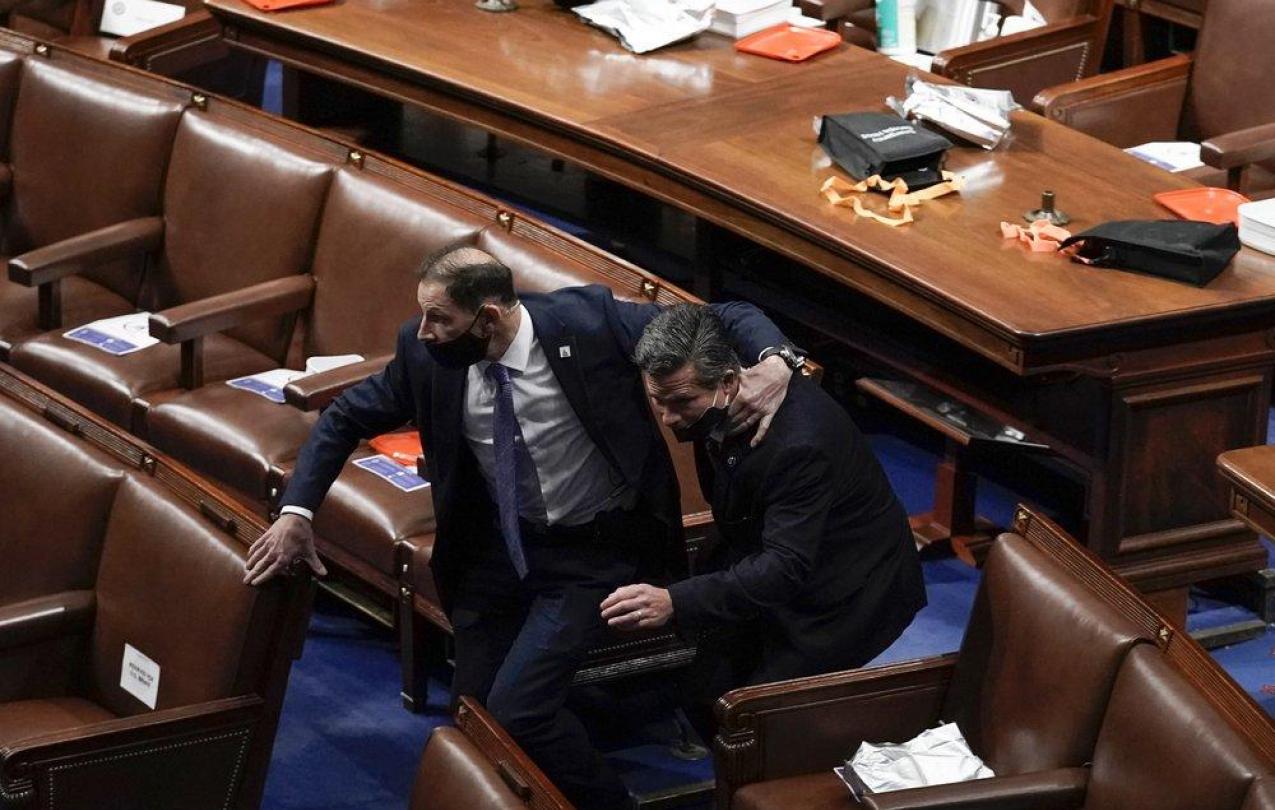 Lawmakers evacuate the floor as protesters try to break into the House Chamber at the U.S. Capitol on Wednesday, Jan. 6, 2021, in Washington. (AP Photo/J. Scott Applewhite)